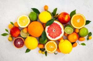 Assorted fresh citrus fruits with leaves